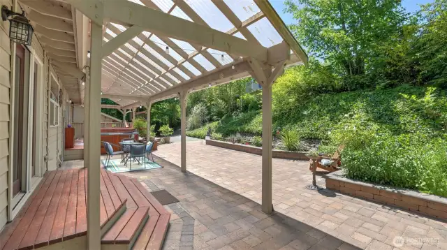 Step out onto a gorgeous, serene porch featuring a partial covered area and surrounded by lush greenery!