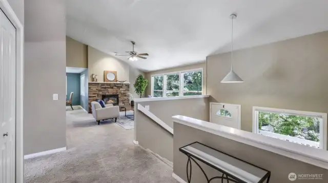 Wide staircase leads to a spacious upper level, where open-concept living blends sophistication with everyday comfort.