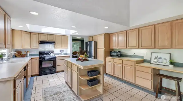 Enjoy a sunlit kitchen with a skylight overhead and the bonus of included appliances—ready for your culinary adventures.