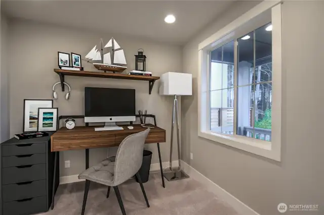 Main level bedroom in front of home adjacent to dinning room virtually staged as home office