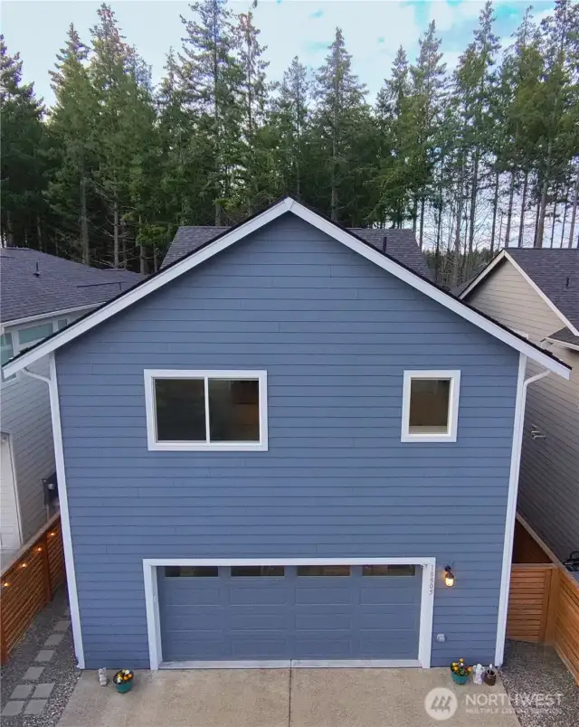 Back of home with 2 car garage faces cul-de-sac/alleyway access to street