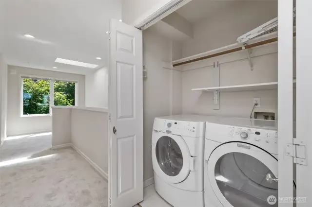 Laundry area on upper floor with Office space  next to windows.