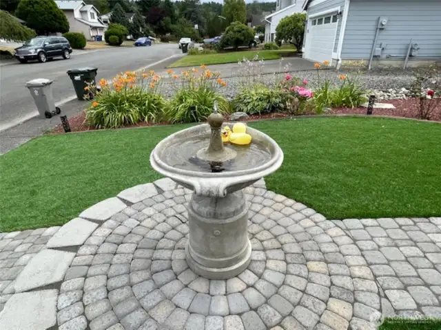 Custom pavers leading  to the center water fountain give this home the WOW factor!