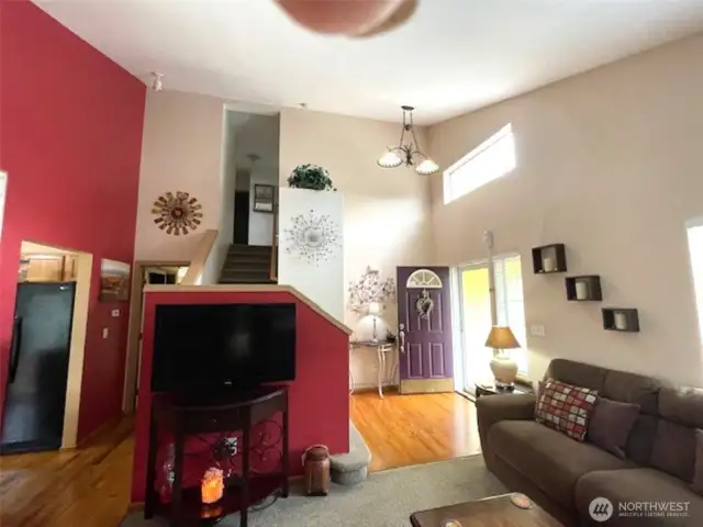 Front entry opens to vaulted ceilings and beautiful artwork through out this home.