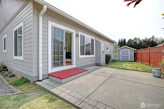 Paved patio space surrounded by beautiful landscaping.