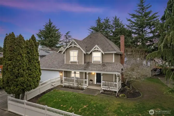 Classic curb appeal welcomes you home with a well-kept exterior, mature landscaping, and a spacious corner lot setting.