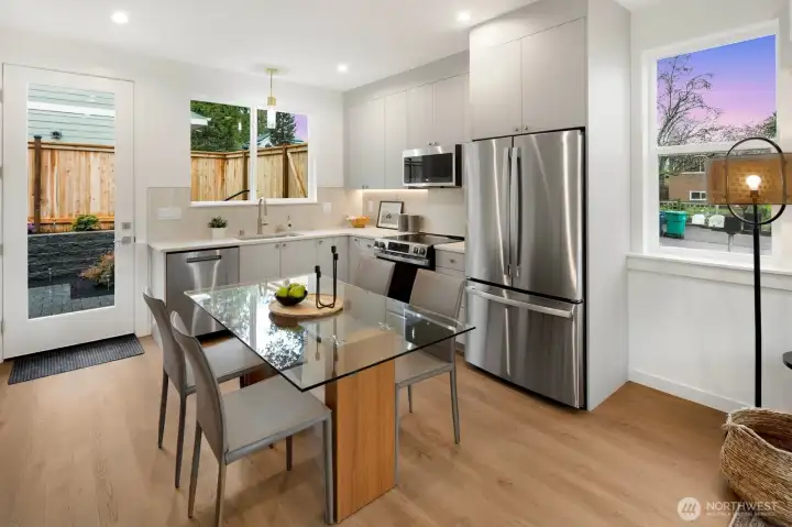 Kitchen has access to a landscaped backyard, patio with pavers and fully fenced.