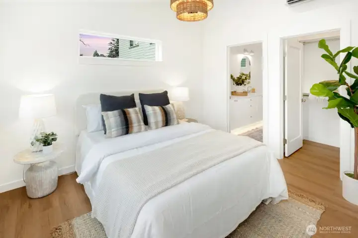 Primary Suite has a custom tiled shower, dual vanity and walk-in closet. Vaulted ceilings