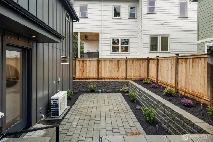 Fully fenced backyard patio.