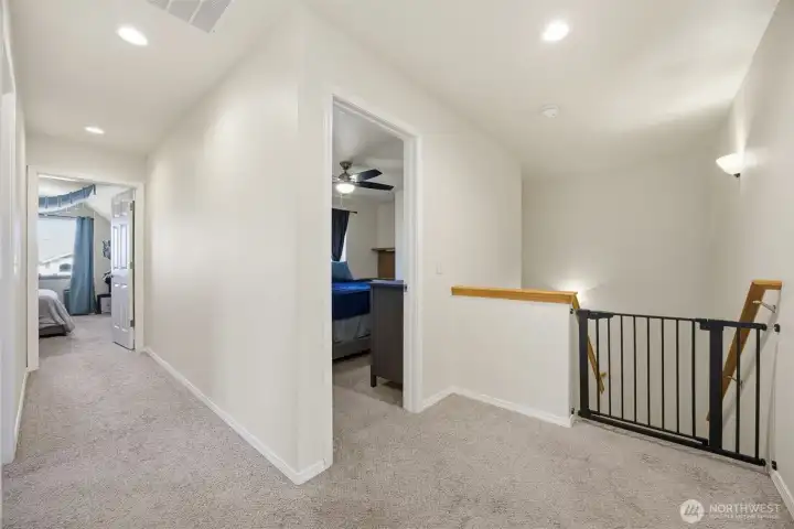 Upstairs hallway looking into bonus room and third bedroom
