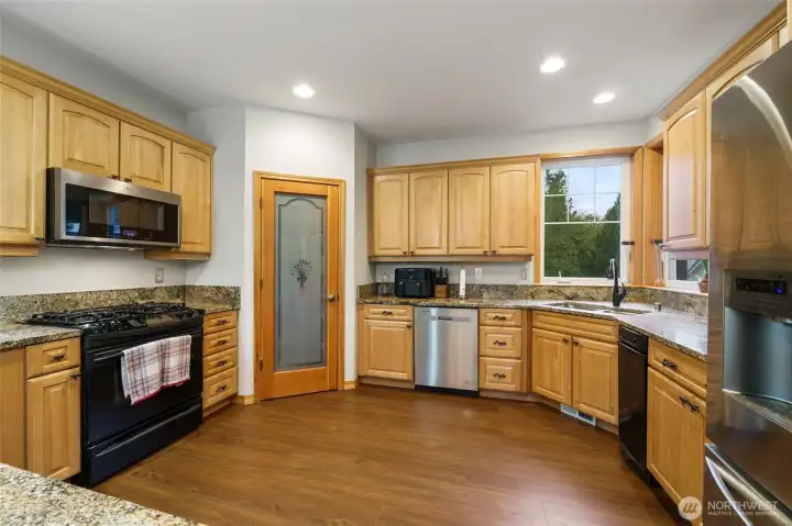 Abundance of cabinetry and counter space plus a walk-in pantry that offers ample storage.