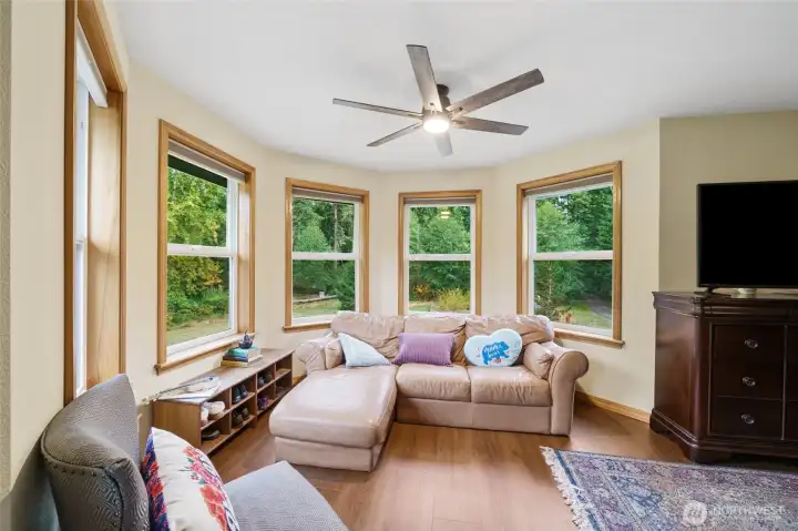 Sitting area with forest views in the primary bedroom.