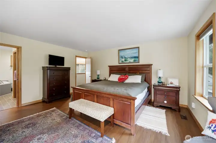 Another view of the primary bedroom with an adjoining private bath.