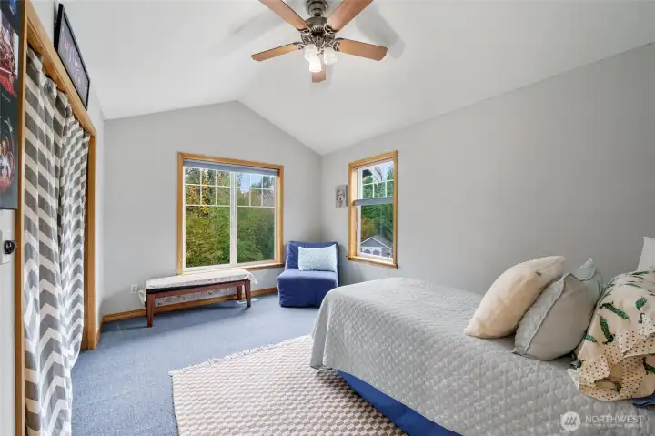 Upper-level guest room with abundant natural light.