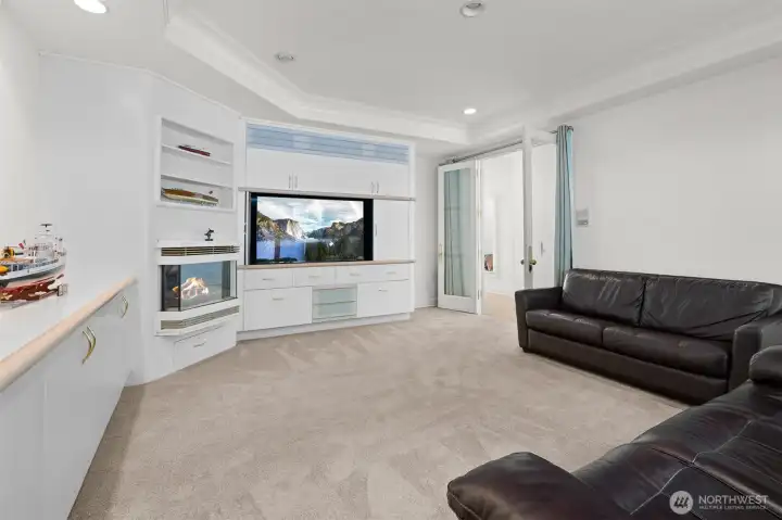 Media room with extensive built-ion cabinets & fire place.