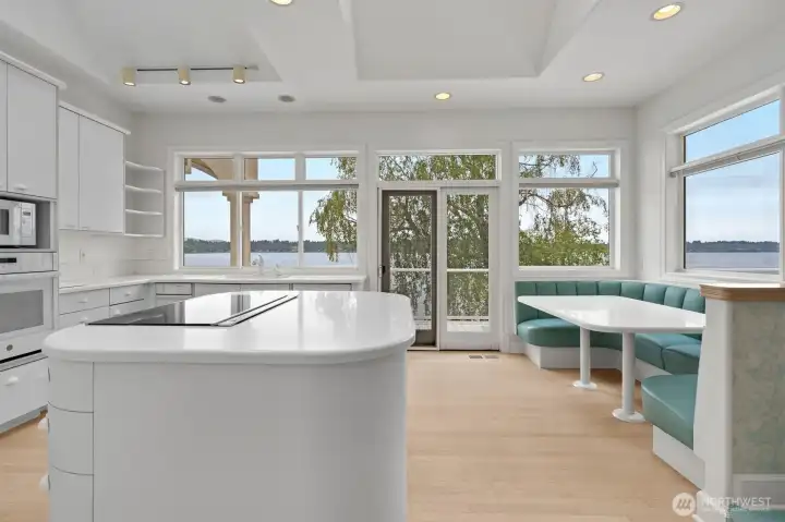 Pristine kitchen with center isle and built in seating area.  Also a pantry, nor visible in this photo.