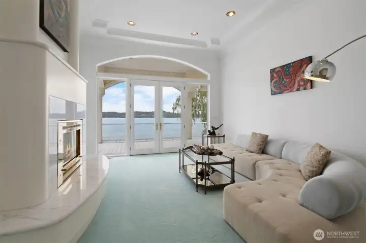 Living room on the main floor with a fireplace and custom furniture.