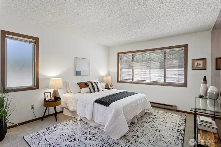 The spacious primary bedroom provides a peaceful sanctuary. New carpet and paint throughout.