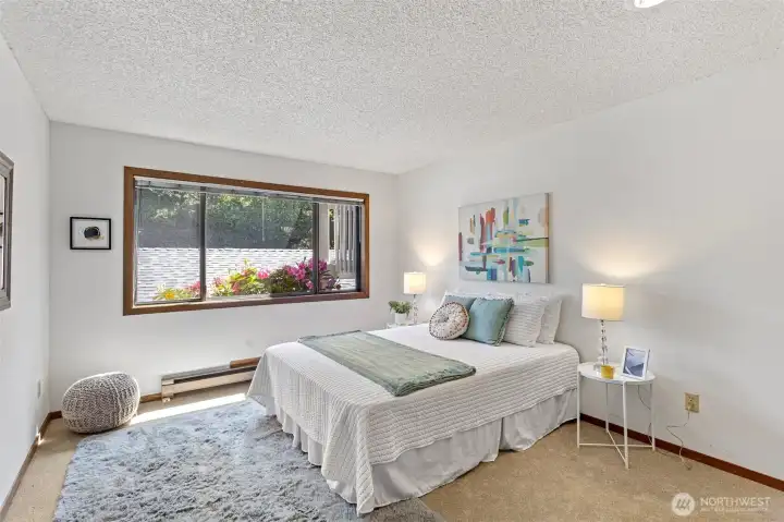 The large second bedroom framed with colorful rhododendrums at this time of year!