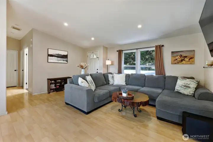 Spacious & light filled living room w/ vaulted ceiling