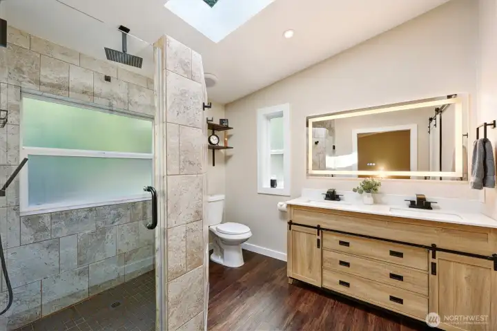 Primary ensuite is updated with custom shower surround tile 7 new dual sink vanity