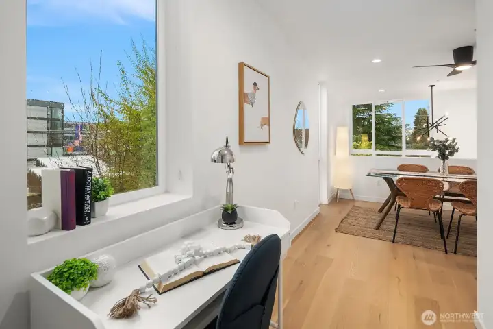 Versatile loft space with engineered hardwood floors, bright city-view windows, and an open layout perfectly suited as a home office, creative studio, or additional dining area.
