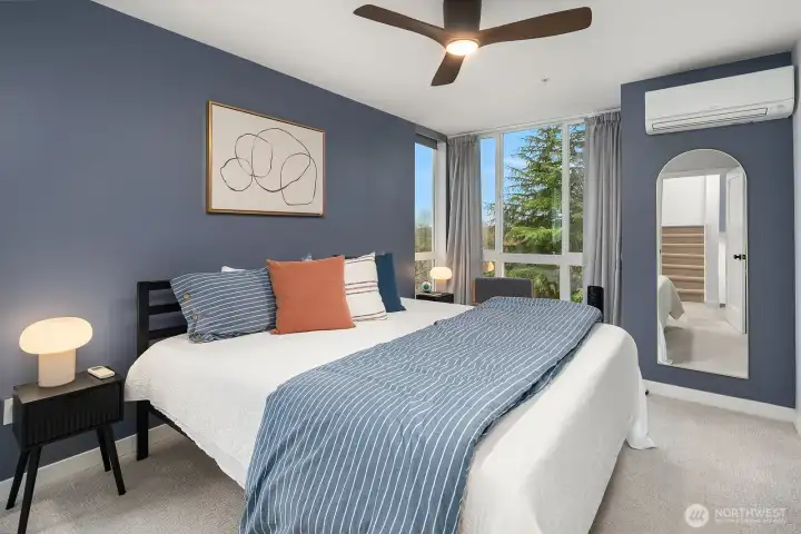 Comfortable and well-appointed guest bedroom with plush new carpet, a ceiling fan, and a bright door leading to a private outdoor space for added flexibility and convenience.