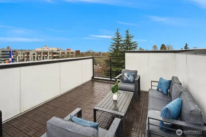 Expansive private rooftop deck with comfortable lounge seating, sweeping open sky and neighborhood views, and an ideal setting for entertaining or unwinding above the energy of the city.