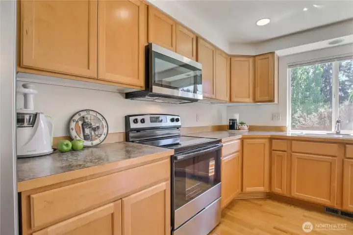 Wall of maple cabinets and spaciouse countertops