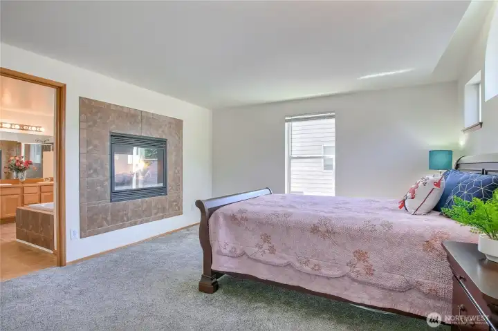 Fireplace between primary and suite bath
