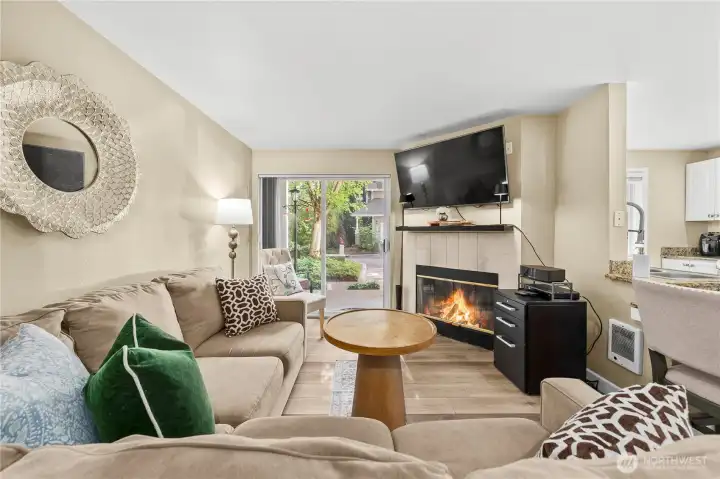 Cozy living room featuring natural wood burning fireplace