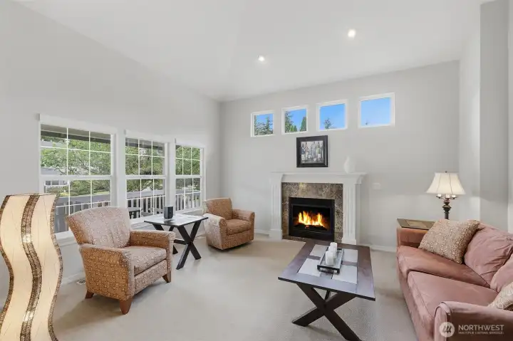 Light and bright living room features soaring ceilings and cozy gas fireplace. Light and bright living room features soaring ceilings and cozy gas fireplace.