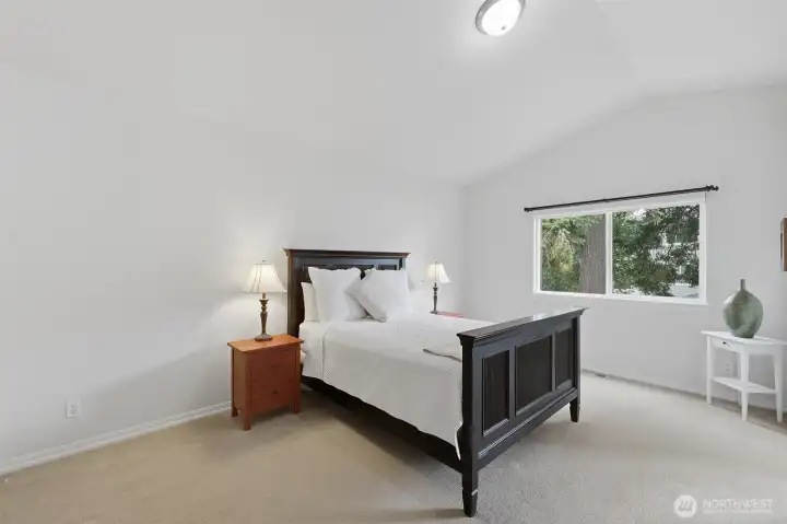 Large primary bedroom with vaulted ceilings and walk-in closet. Large primary bedroom with vaulted ceilings and walk-in closet.