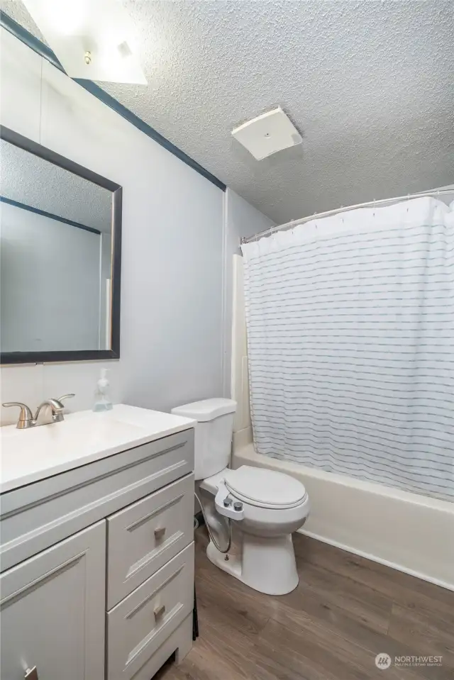 THE BATHROOM | Features a tub/shower unit and an updated vanity.