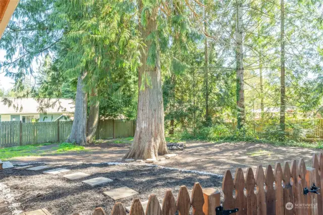 FROM THE RIGHT SIDE OF THE HOME | A cute picket fence keeps the back yard contained.