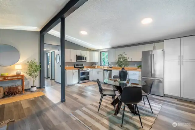 OPEN CONCEPT LIVING | This kitchen is brand new and beautiful. Renovated just days before it went on the market, you'll love the shaker cabinets, stainless steel appliances, and butcher block countertops.