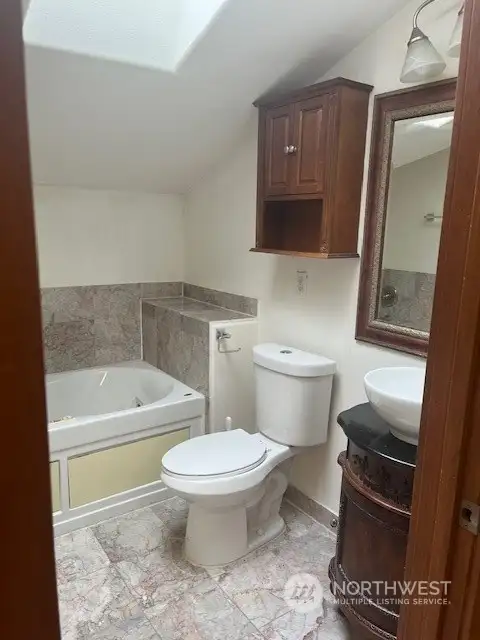 The main bedroom flows into an oversized full bathroom.