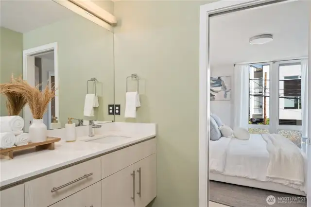 Hall bath with large walk-in shower adjoins primary bedroom.