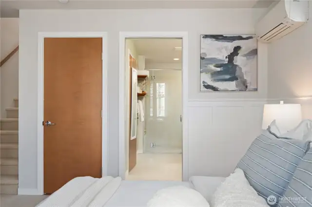 Primary bedroom with custom wainscoting and adjoining ensuite bath