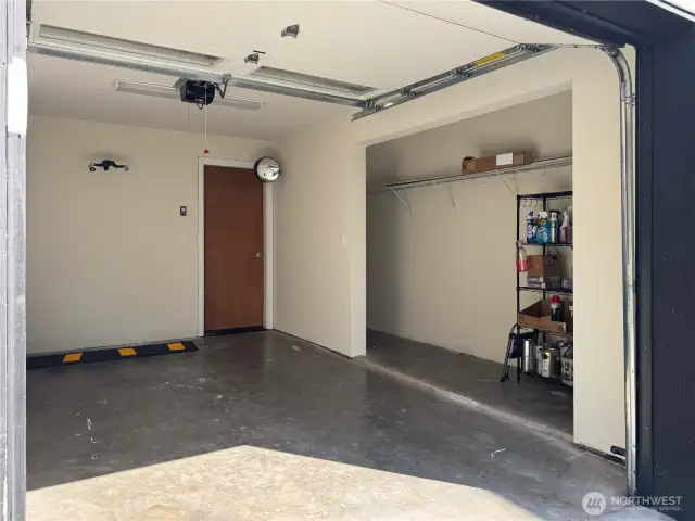 Attached 1-car garage with storage alcove