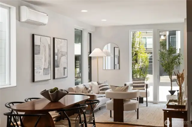 Light filled living/dining room with floor to ceiling windows