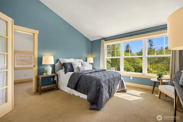 Vaulted ceiling and large windows bathe the room in natural light
