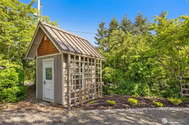 Outbuilding for garden storage features a "hidden" play area