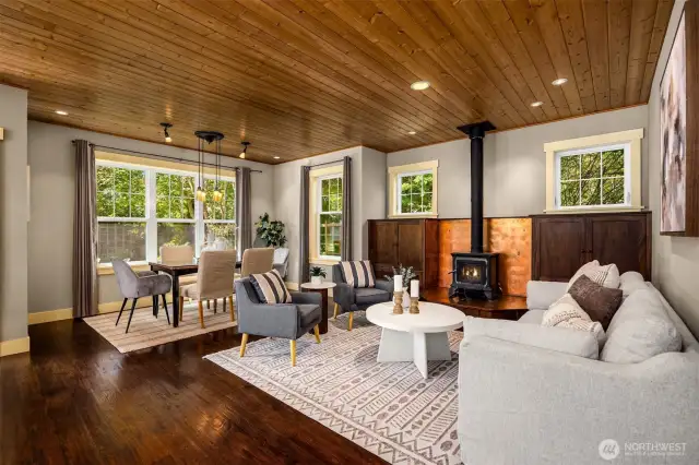 The open-concept living area has a warm, timeless feel and features pine ceilings and designer finishes