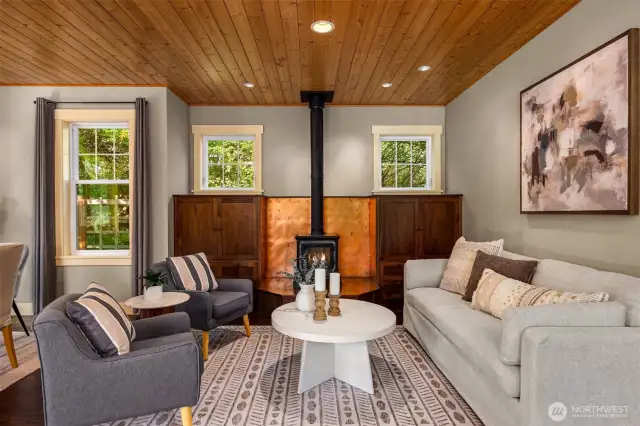 Cozy up to the soapstone woodstove with custom copper surround flanked by mahogany cabinetry