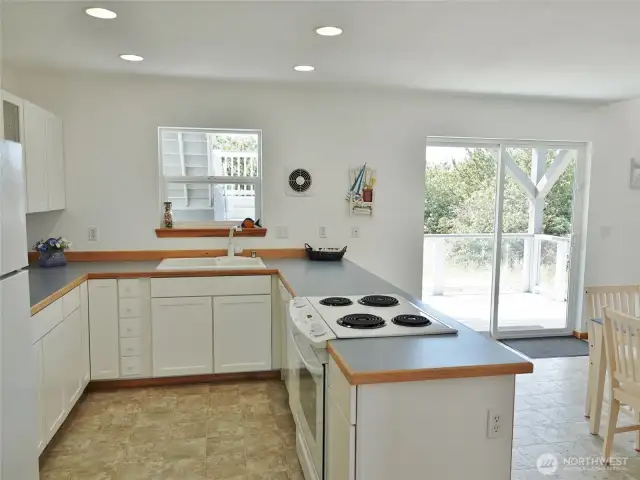 Lovely Kitchen w/ white cabinets and lots of counter space.