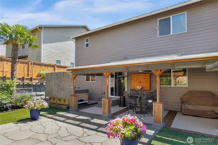 Patio cover protects from rain & sun. Drop-down shades retain heat during winter.