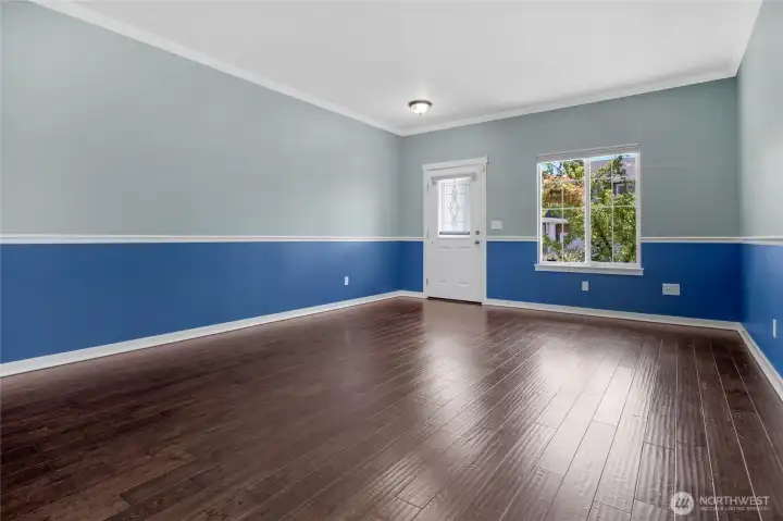 Flexible entry area and front room features custom molding and solid oak floors.