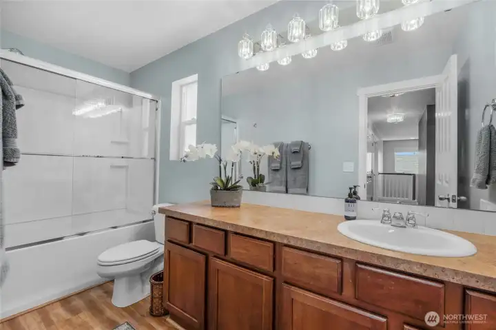 Large shared guest bathroom with new tub enclosure.