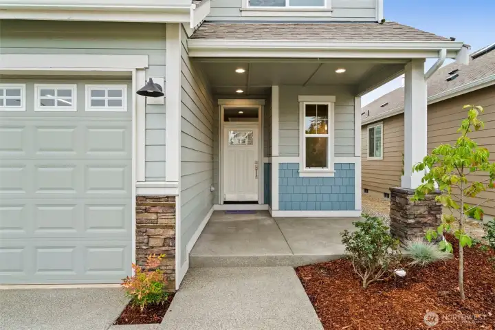 Relax and enjoy the oversized covered front porch with decorative stone panels.